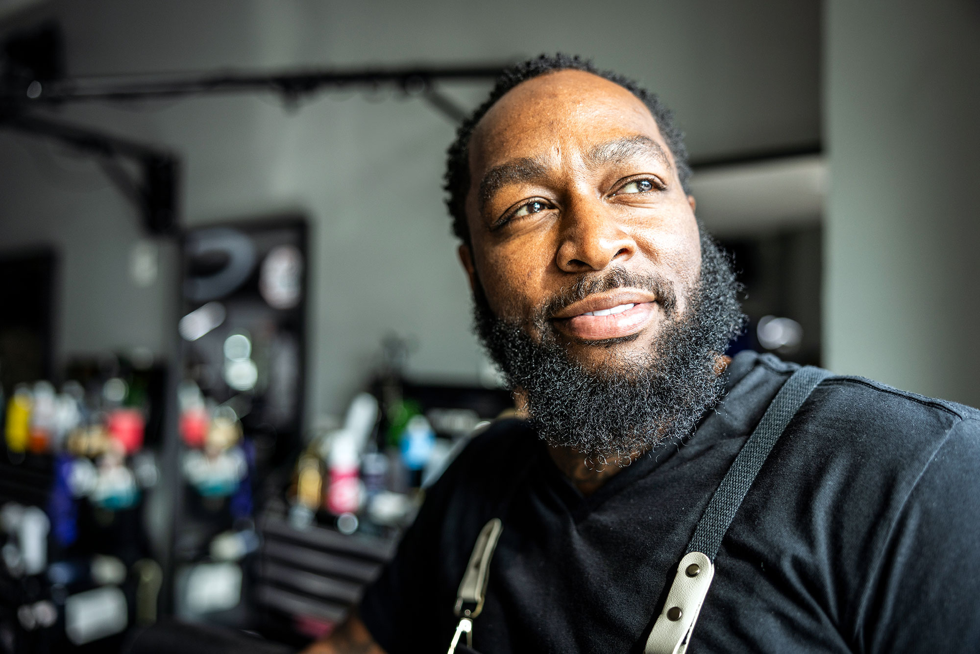 a man with a beard and a black shirt in a workplace